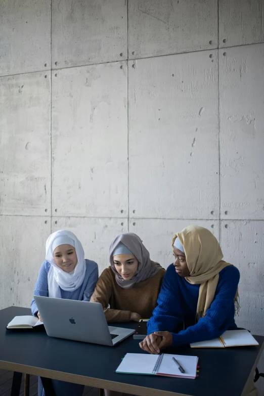 three women sitting at a table with a laptop, by Maryam Hashemi, trending on unsplash, academic art, hijab, engineering, grey, cornell