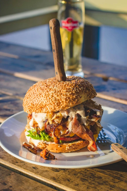 a close up of a sandwich on a plate on a table, by Sebastian Spreng, unsplash, barbecue, hamburger, coastal, outback