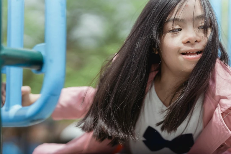 a close up of a child on a slide, pexels contest winner, hurufiyya, asian girl with long hair, sitting in a wheelchair, swings, 15081959 21121991 01012000 4k