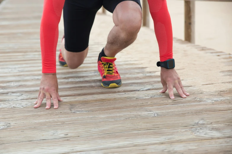 a man in red and black running on a boardwalk, knee pads, connectivity, zoomed in, a wooden