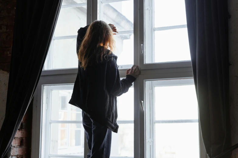 a woman that is standing in front of a window, happening, struggling, window lighting, profile image, black windows