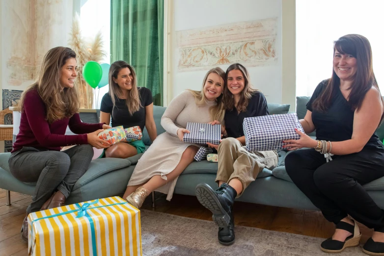 a group of women sitting on top of a couch, by Emma Andijewska, pexels contest winner, happening, birthday wrapped presents, avatar image, giorgia meloni, at a birthday party