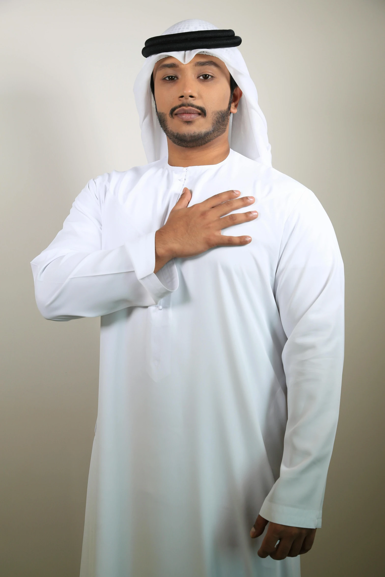 a man in a white robe posing for a picture, an album cover, inspired by Sheikh Hamdullah, pexels contest winner, arms crossed on chest, no - text no - logo, basic background, tunic