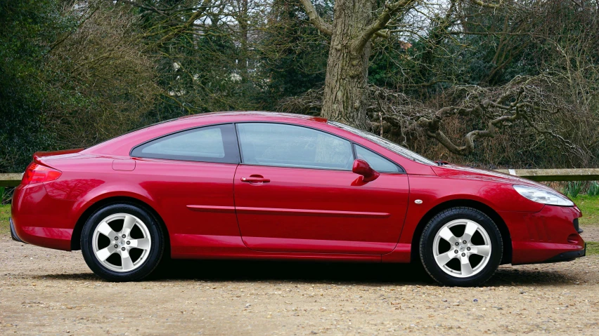 a red car parked on the side of a dirt road, renaissance, late 2000’s, peugeot prestige, cut-away, 2006 photograph