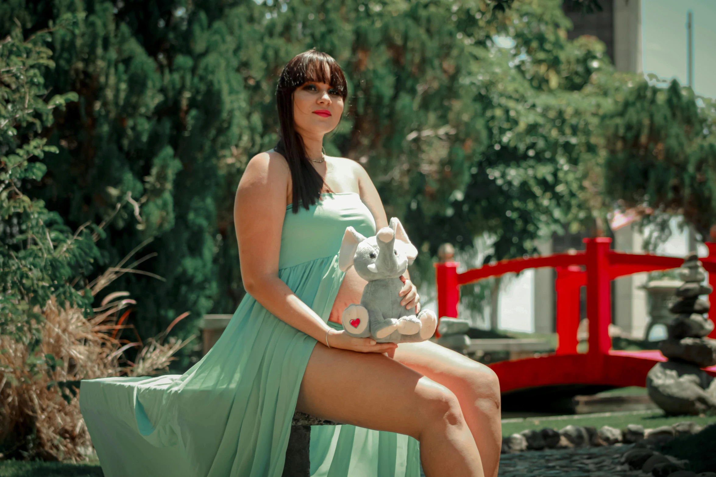 a woman in a green dress sitting on a bench, maternity feeling, playboy bunny, avatar image, uploaded