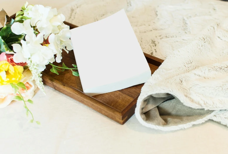 a bouquet of flowers sitting on top of a wooden tray, private press, white cloth, blank paper, product display photograph, rectangular