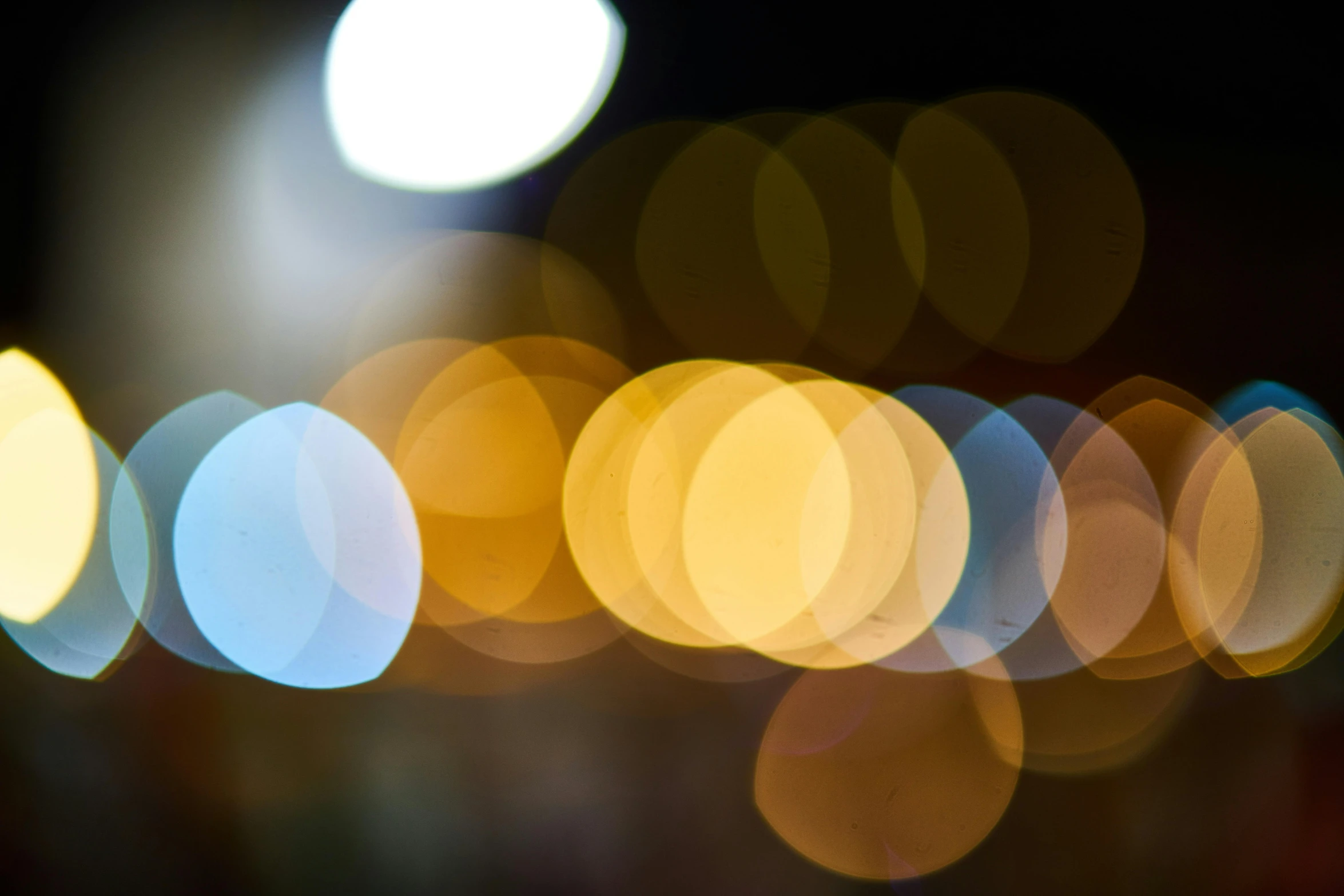 a blurry photo of a city street at night, by Jan Rustem, unsplash, abstract expressionism, light circles, yellowish light, close - up bokeh, circles