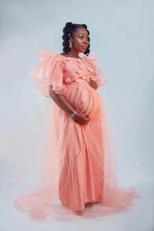 a pregnant woman in a pink dress, an album cover, by Chinwe Chukwuogo-Roy, pexels, pr shoot, peach, age 2 0, high details!