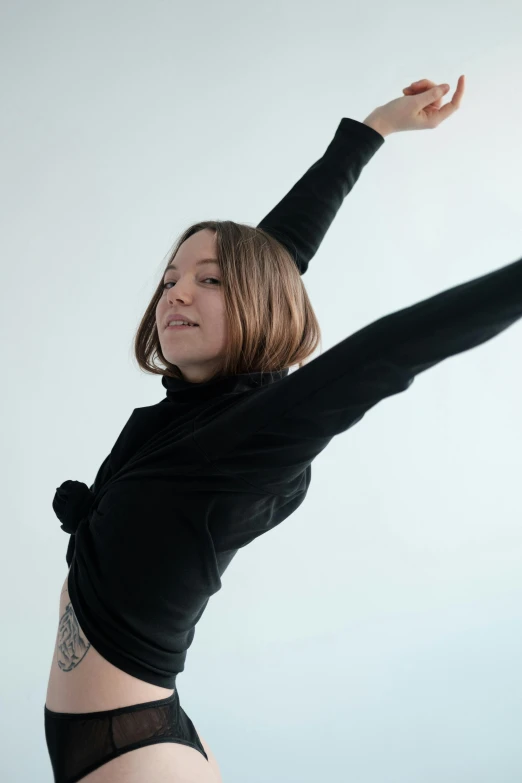 a woman in a black top is holding a frisbee, inspired by Elizabeth Polunin, wearing a turtleneck and jacket, arms stretched out, pokimane, profile image