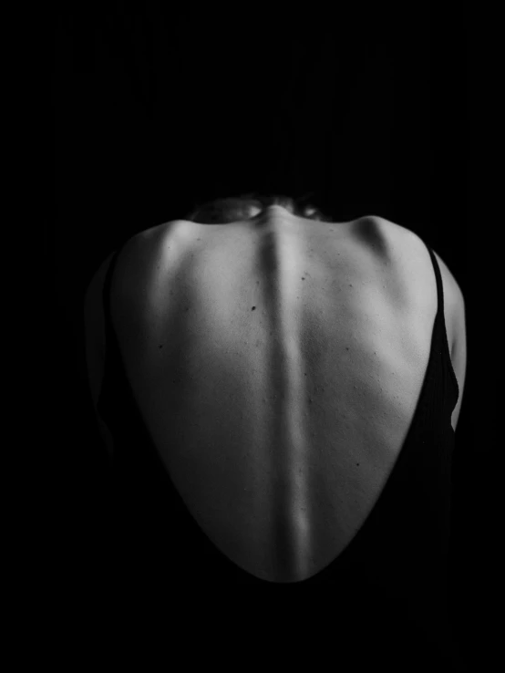 a black and white photo of a woman's back, inspired by Robert Mapplethorpe, unsplash, figurative art, dark and scary, diana levin, humanoid woman, & a dark