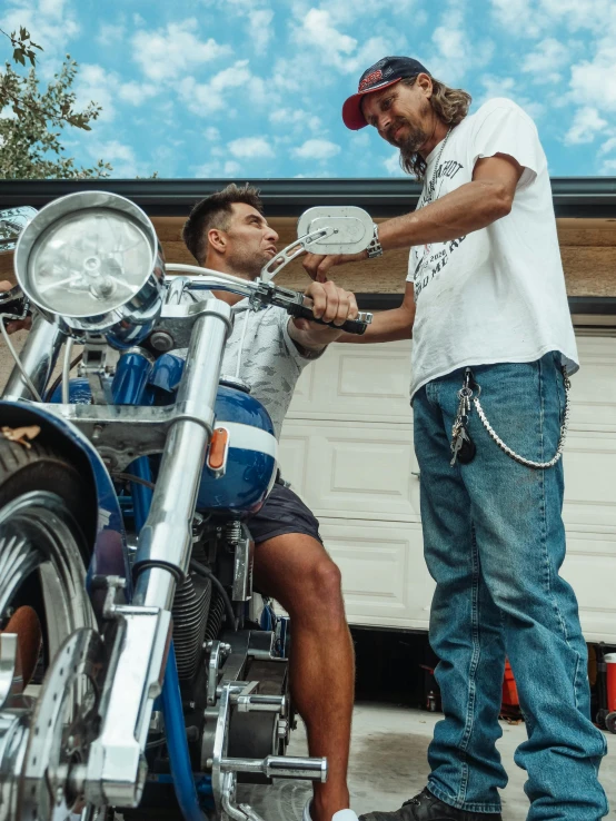 a man standing next to a man on a motorcycle, profile image, holding a wrench, taken in 2 0 2 0, florida man