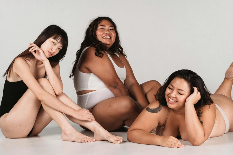 a group of women sitting on top of a white floor, curvy body, asian descent, different sizes, as 3 figures