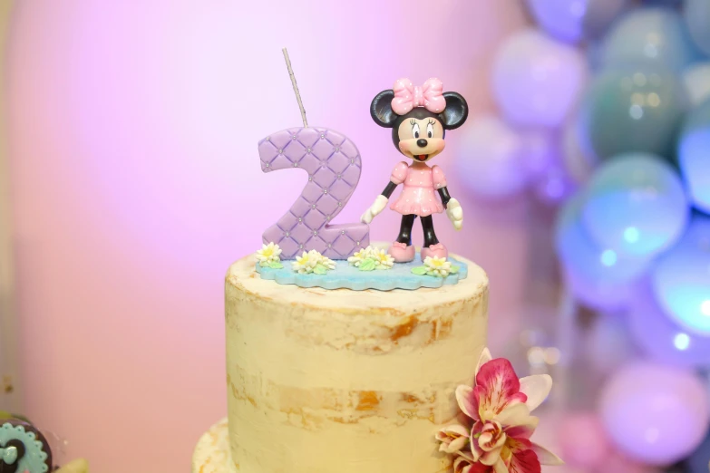 a birthday cake with a minnie mouse topper, a cartoon, by disney, pexels, happening, 2 years old, candle lighting, pastel color theme, mini figure