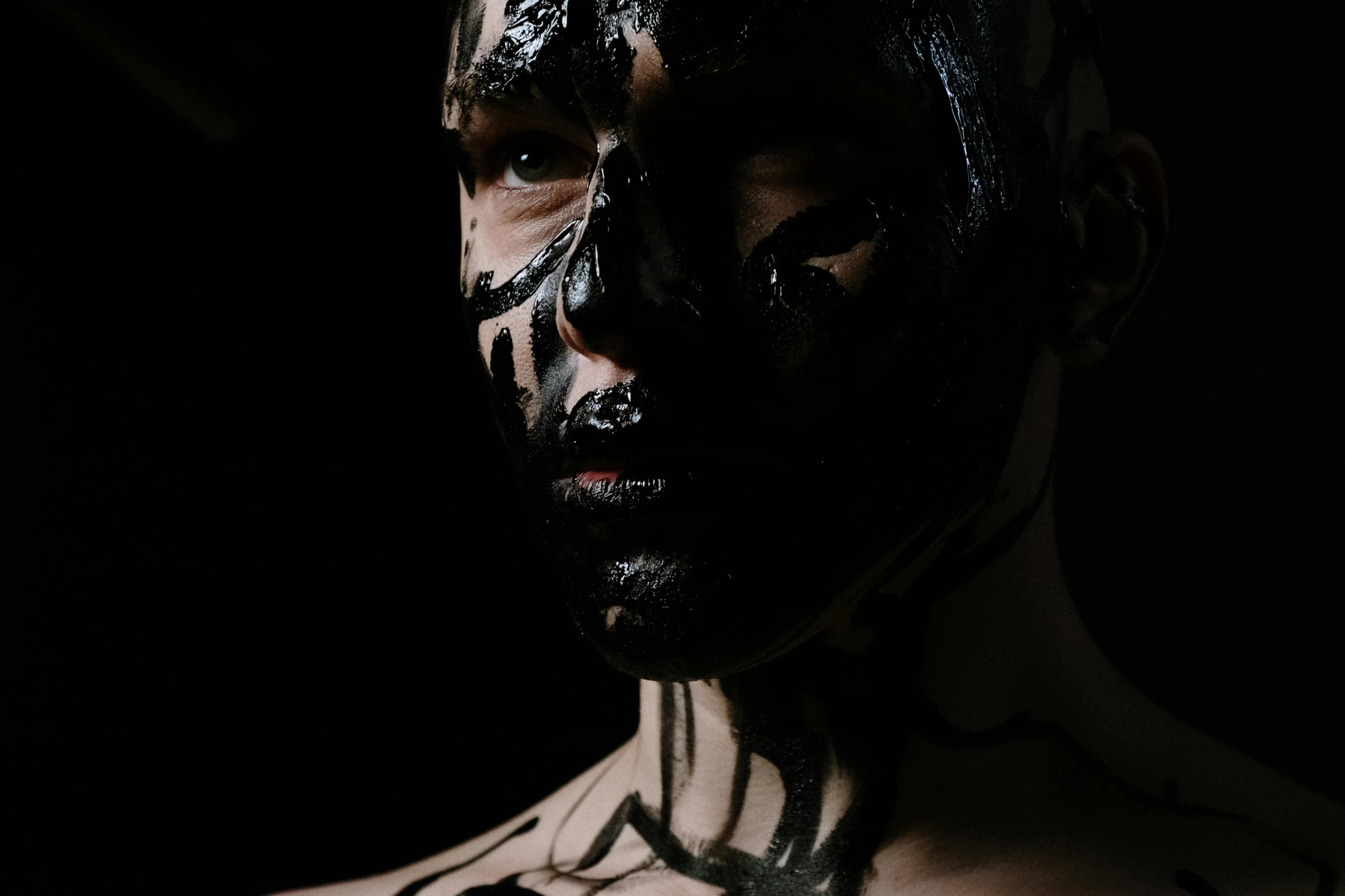 a man with black paint on his face, an album cover, pexels contest winner, antipodeans, cyborg fashion model, zezhou chen, body painted with black fluid, cardboard