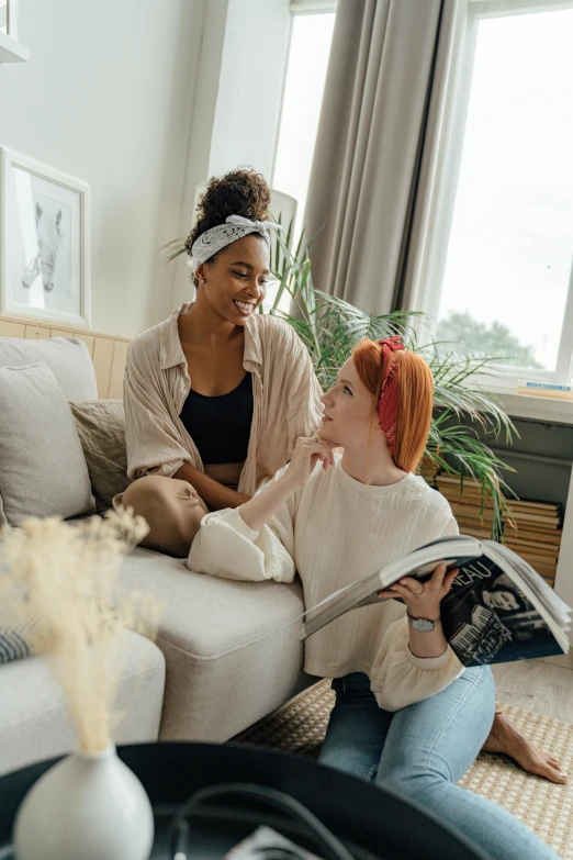 two women sitting on a couch in a living room, pexels contest winner, renaissance, redhead woman, varying ethnicities, trending on pinterest. com, inside a cozy apartment