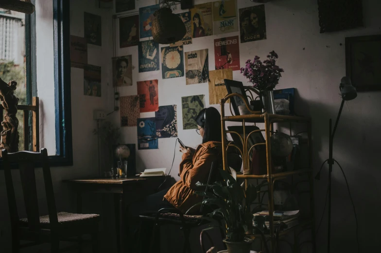 a person sitting in a chair in front of a window, trending on pexels, serial art, girl in a record store, background image, an escape room in a small, an asian woman