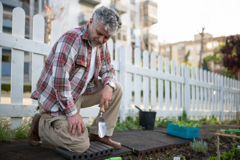 a man that is kneeling down in the dirt, homes and gardens, profile image, thumbnail