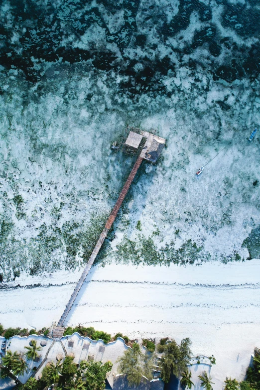 a large body of water next to a beach, inspired by Simon Stålenhag, pexels contest winner, entrapped in ice, dji top down view, big hammer, near a jetty
