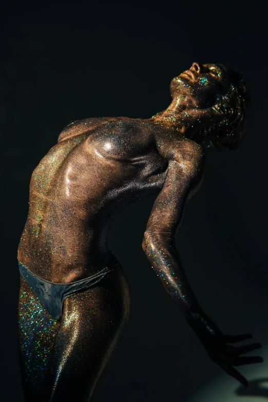 a man that has some paint on his body, a statue, inspired by Hedi Xandt, featured on zbrush central, glittery, unsplash contest winning photo, pose 4 of 1 6, made of bronze