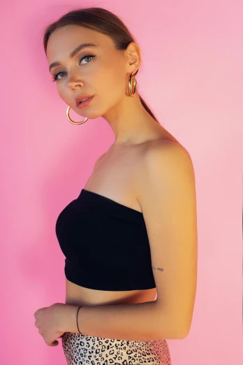 a woman in a black top and leopard print skirt, an album cover, by Julia Pishtar, trending on pexels, pink halter top, 🤤 girl portrait, posing in bra, profile portrait