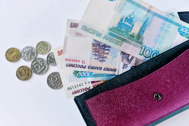 a wallet full of money sitting on top of a table, by Emma Andijewska, pexels contest winner, socialist realism, kremlin, mauve and cinnabar and cyan, 🦩🪐🐞👩🏻🦳, thumbnail