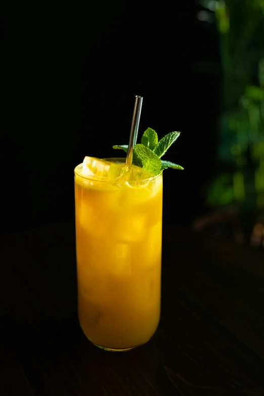a drink sitting on top of a wooden table, mango, mint, long chin, ivy's