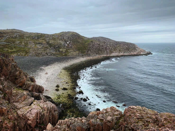 a large body of water next to a rocky shore, by Terese Nielsen, pexels contest winner, les nabis, gungnir, gravel and scree ground, conde nast traveler photo, hills and ocean
