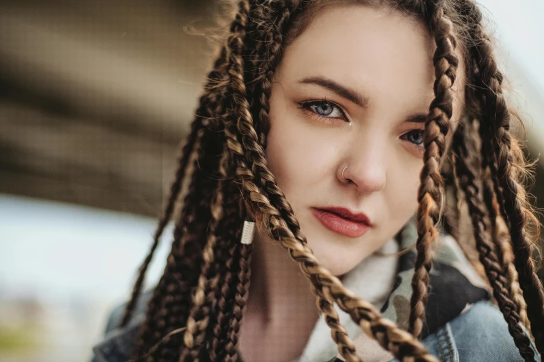 a close up of a person with long hair, a portrait, trending on pexels, braids, septum piercing, attractive brown hair woman, retro stylised