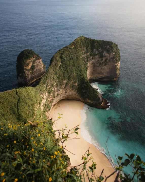 a large body of water next to a sandy beach, by Matija Jama, pexels contest winner, sumatraism, ocean cliff view, bella poarch, big arches in the back, conde nast traveler photo