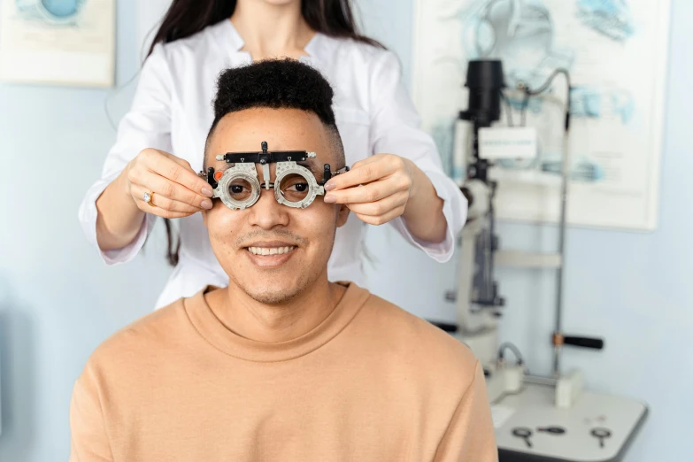 a man getting an eye exam at a doctor's office, a picture, trending on pexels, hurufiyya, playful smirk, damien tran, with multiple eyes, mechanics