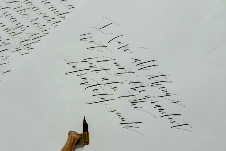 a pen sitting on top of a piece of paper, inspired by Zsolt Bodoni, letterism, on a gray background, various sizes, très détaillé, made of silk paper