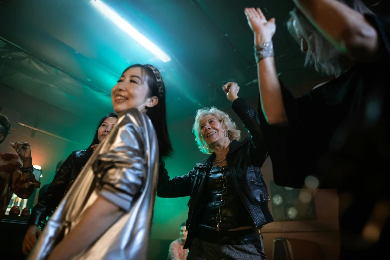 a group of women standing on top of a stage, inspired by Nan Goldin, trending on pexels, happening, line dancing at a party, japanese live-action movie, 15081959 21121991 01012000 4k, shining and happy atmosphere