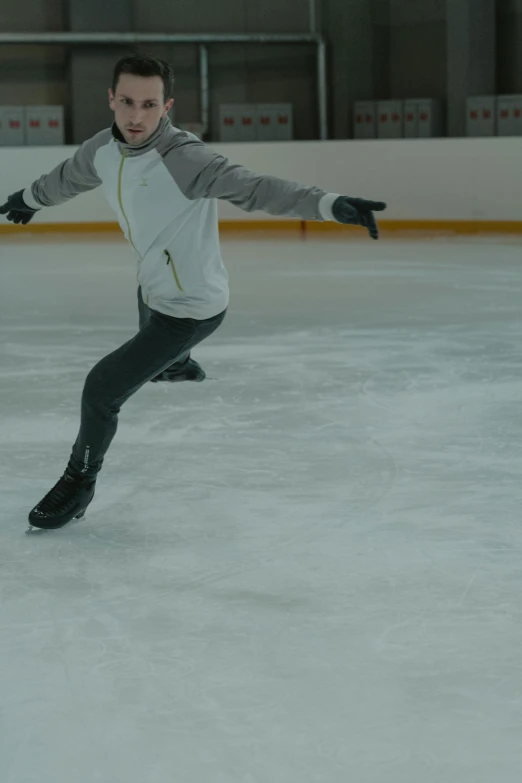 a man is skating on an ice rink, arabesque, smiling with confidence, aged 13, super smooth lines, f 1.4