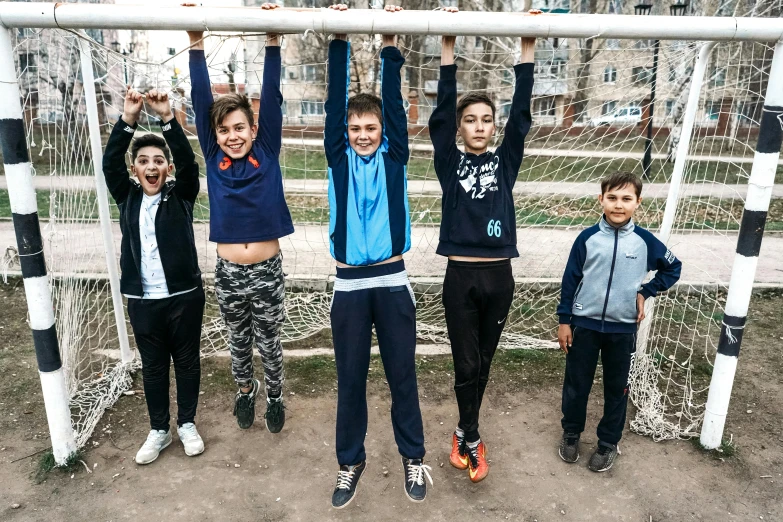 a group of young people standing in front of a soccer goal, pexels contest winner, danube school, six arms, ukrainian, urban playground, 15081959 21121991 01012000 4k