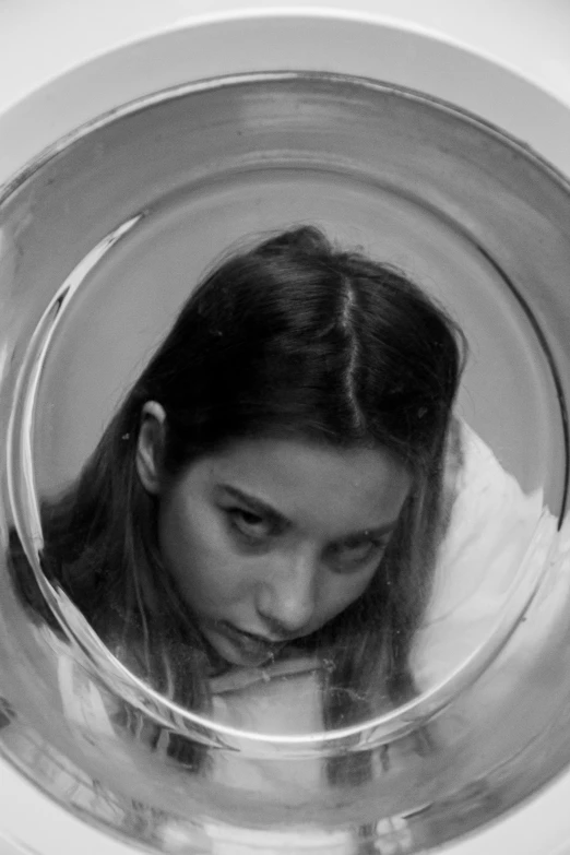 a black and white photo of a woman in a washing machine, inspired by irakli nadar, tumblr, fish lens, florence pugh, inside a glass jar, ana de armas portrait