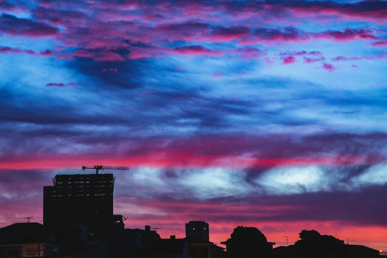 a sky filled with lots of purple and blue clouds, a photo, by Lee Loughridge, pexels contest winner, city sunset, buenos aires, magenta and blue, instagram post