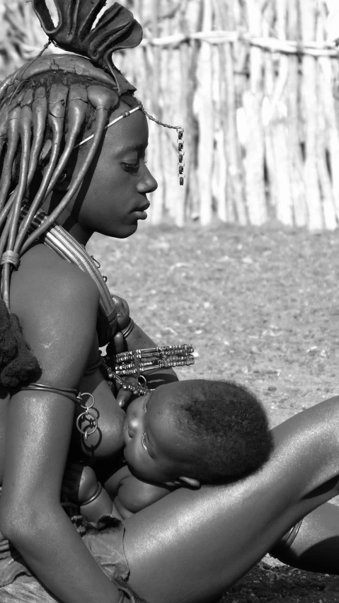 a black and white photo of a woman holding a baby, by Hubert van Ravesteyn, afrofuturism, himba hairstyle, resting on chest, black teenage girl, 8k photo