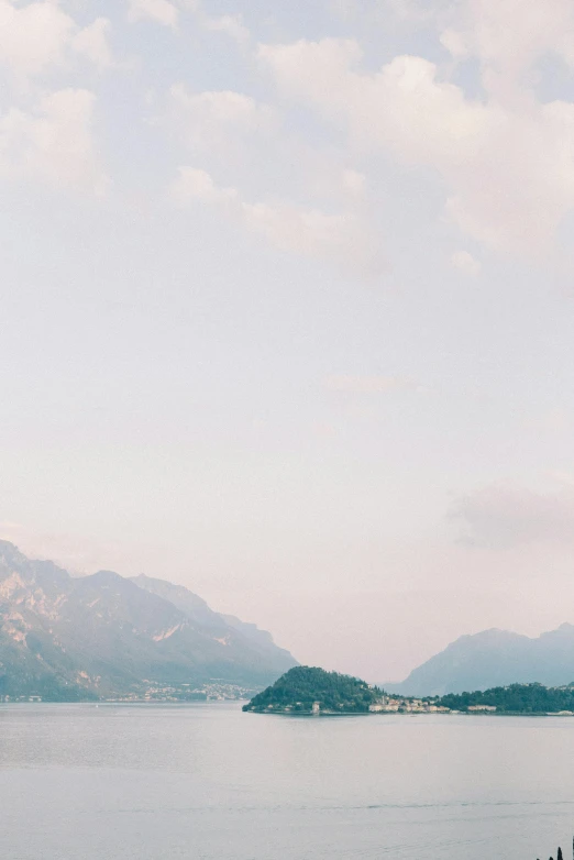 a large body of water with mountains in the background, romanticism, shot onfilm, soft lilac skies, luca, flatlay