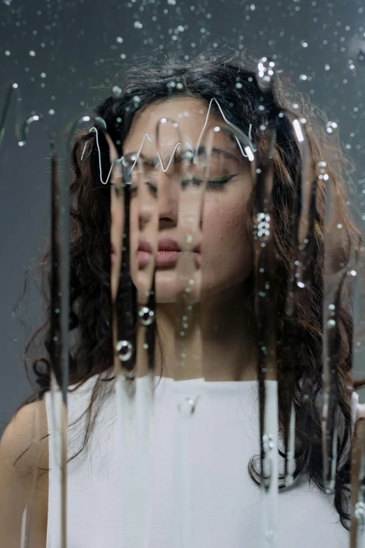 a woman standing under an umbrella in the rain, an album cover, by irakli nadar, conceptual art, hair are cable wires, neri oxman, half face in the water, water coming out of windows