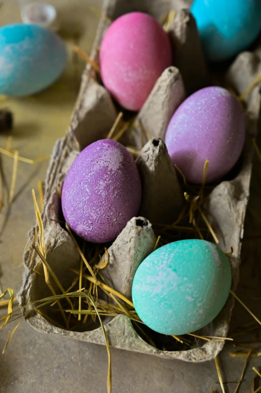 a carton filled with eggs sitting on top of hay, magical sparkling colored dust, colored marble, thumbnail, salt