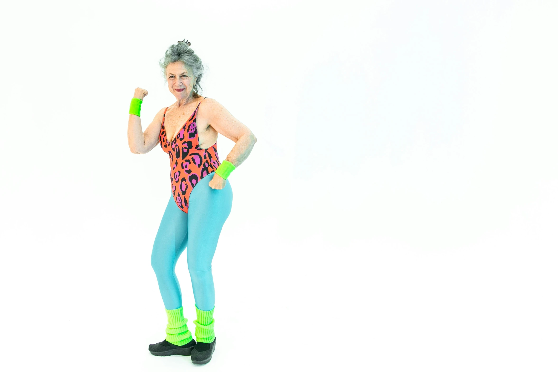 a woman in a colorful top and blue pants, pexels, figuration libre, in spandex suit, an elderly, space jammers, 80s photo