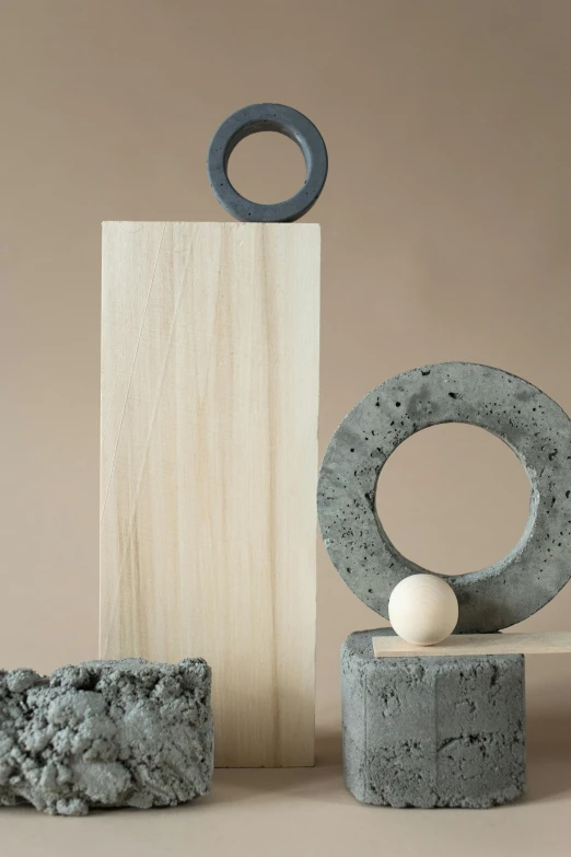 a group of objects sitting on top of a table, inspired by Isamu Noguchi, concrete art, rings, carbon, harbor, detailed product image