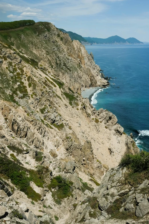 a man standing on top of a cliff next to the ocean, by Carlo Martini, renaissance, south korea, rocky ground with a dirt path, piroca, slide show