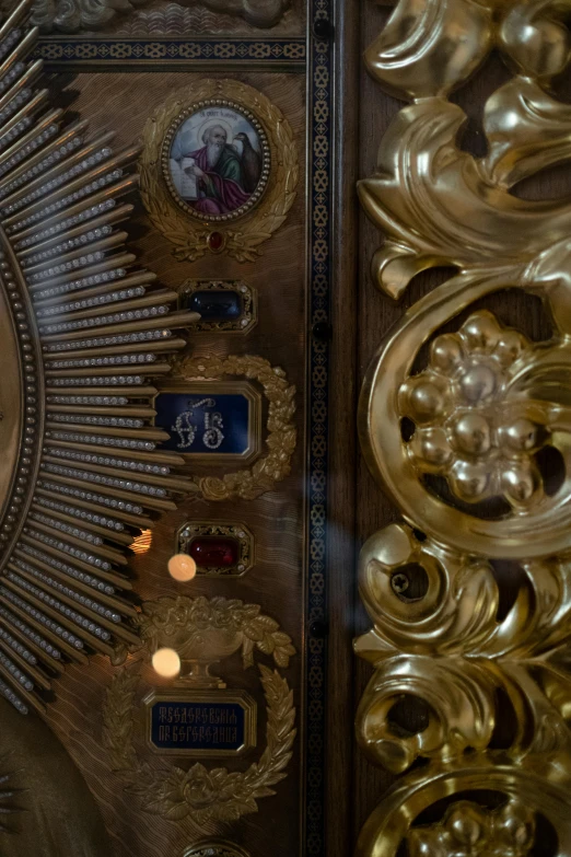 a close up of a clock on a wall, an album cover, inspired by Károly Markó the Elder, baroque, inside the tomb of jesus, gold and gems, wood and gold details, holy light