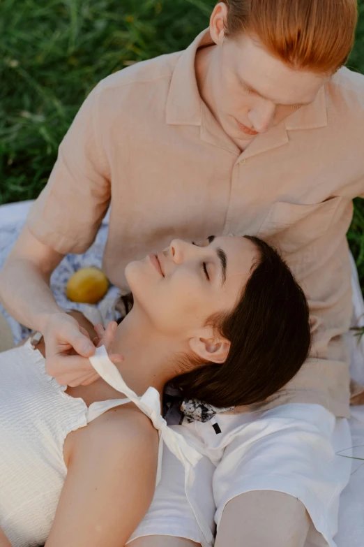 a woman sitting on top of a blanket next to a man, trending on pexels, renaissance, tight around neck, wearing a linen shirt, acupuncture treatment, lawn