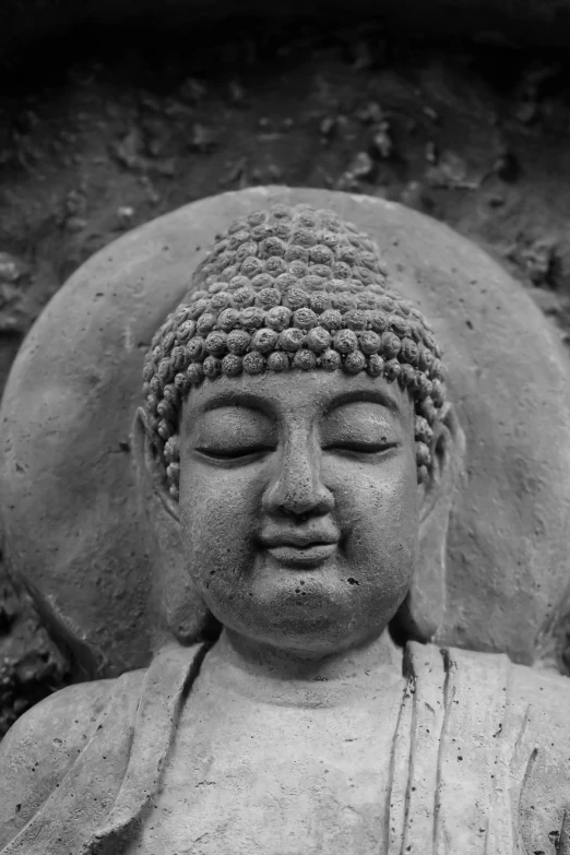 a black and white photo of a buddha statue, a statue, mingei, slightly happy facial expression, made of cement, ben lo, lofi