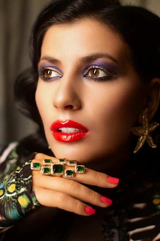a close up of a woman with a ring on her finger, an album cover, indian super model, saci perere, jewel tones, looking towards camera