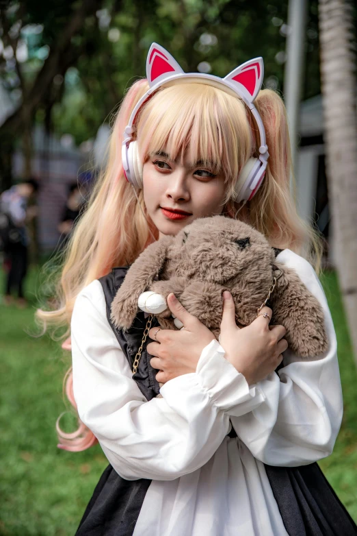 a girl in a costume holding a teddy bear, by Kanbun Master, featured on reddit, pink headphones, halfbody headshot, mai anh tran, a person at a music festival