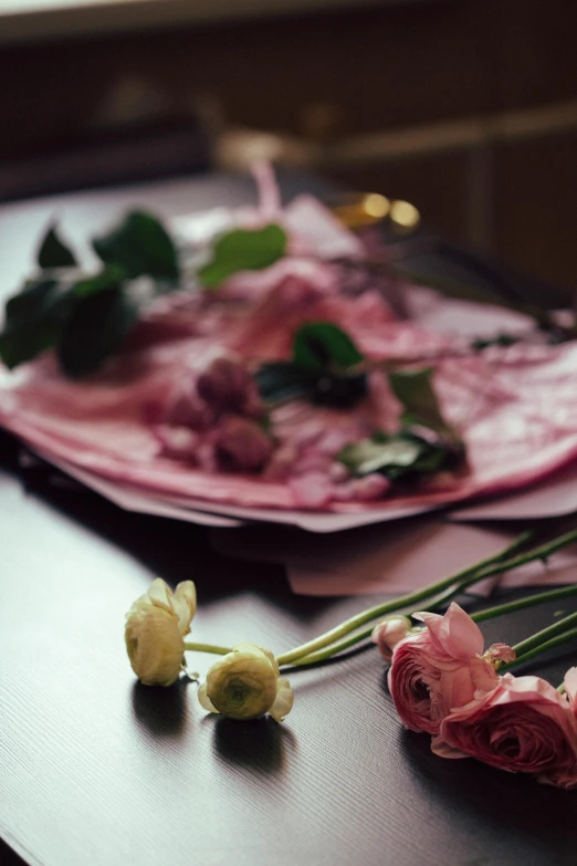 a bunch of flowers sitting on top of a table, a still life, unsplash, romanticism, made of silk paper, covered in pink flesh, ingredients on the table, looking seductive