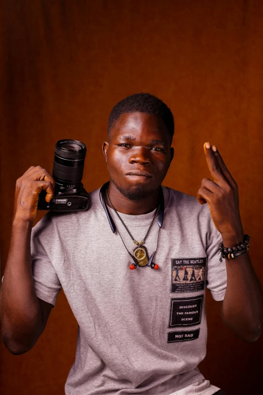a man holding a camera in front of his face, by Chinwe Chukwuogo-Roy, realism, casual pose, around 1 9 years old, professional photo-n 3, flash photograph